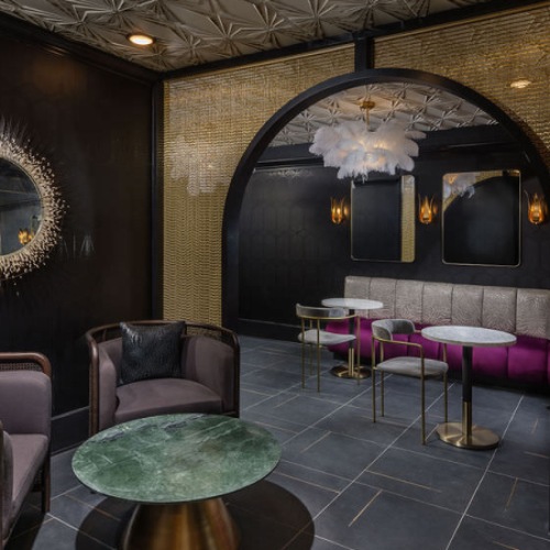 a room with love seats and table