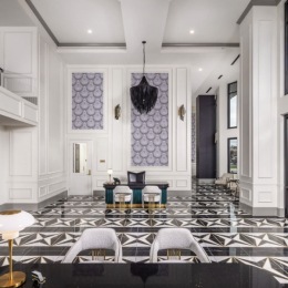 lounge area with bar-style seating, high ceilings, and large open windows