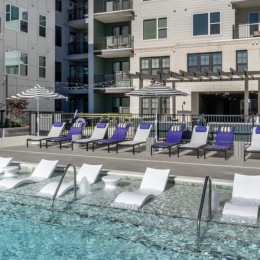 pool area showing reclining seating, wooden coverings and ample space