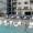 pool area showing reclining seating, wooden coverings and ample space